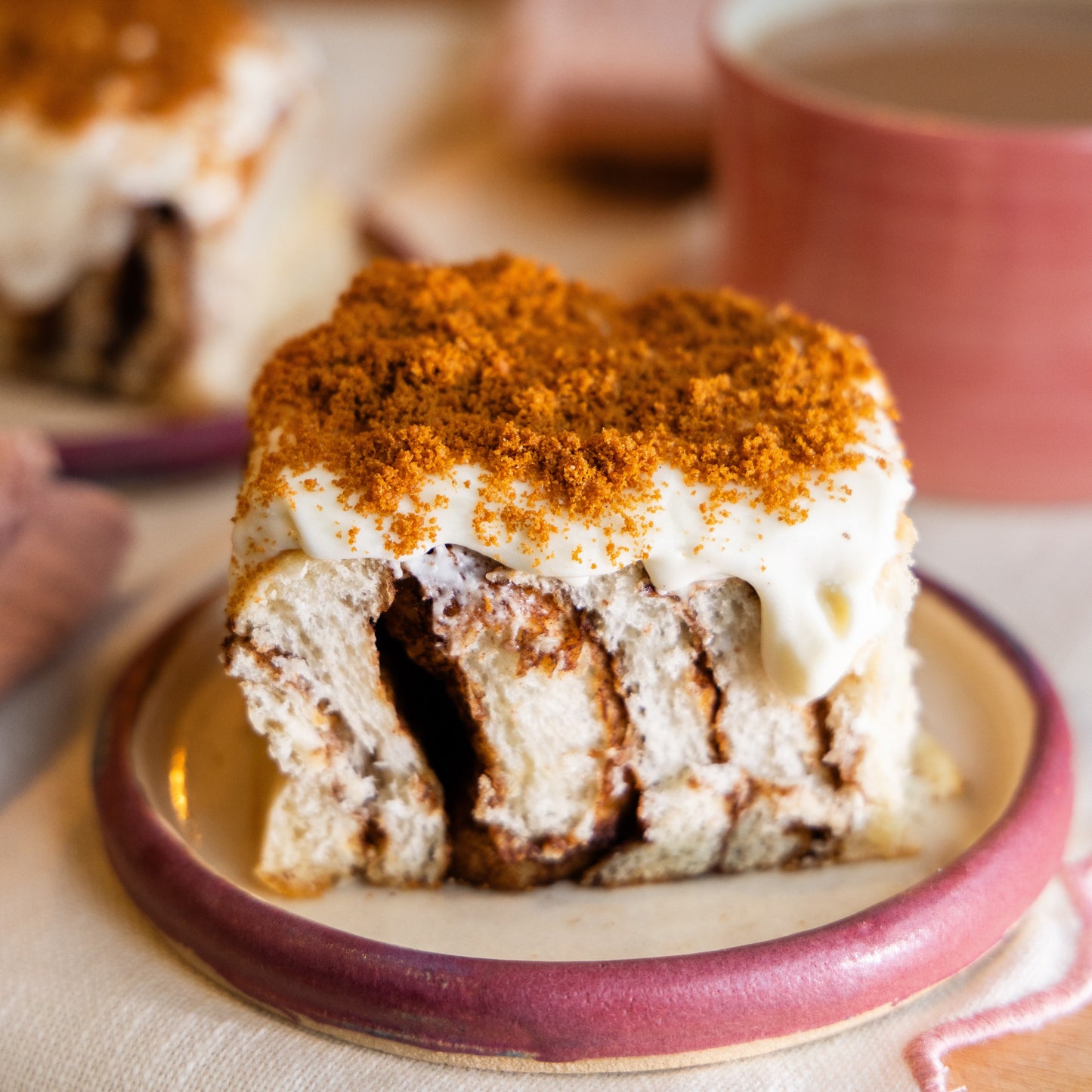 a Biscoff Cheesecake Bun on a pink plate