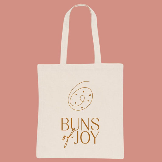 Image of a natural colour cotton tote bag branded with the buns of joy logo